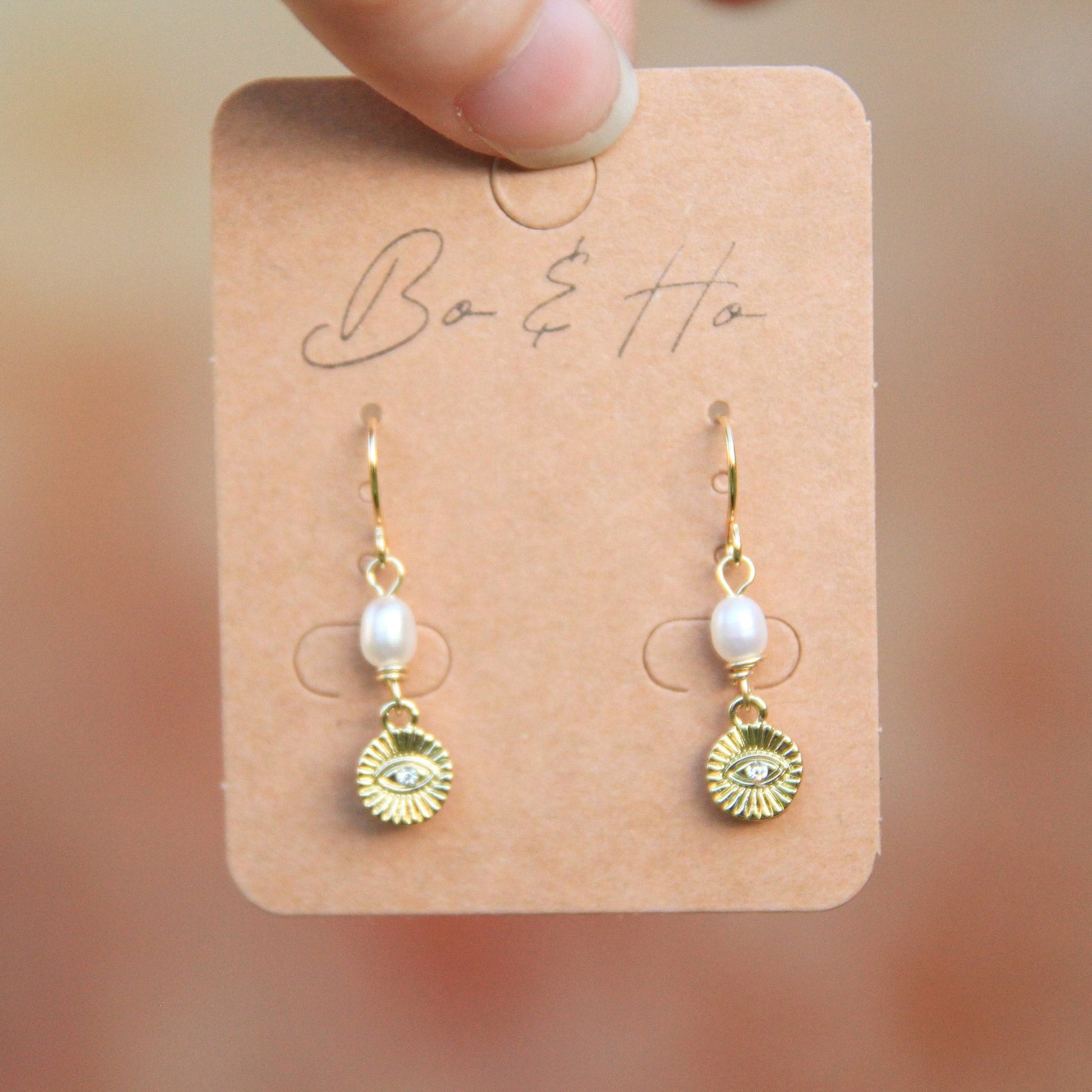 Gold Eye Coin Earrings with Large Freshwater Pearls